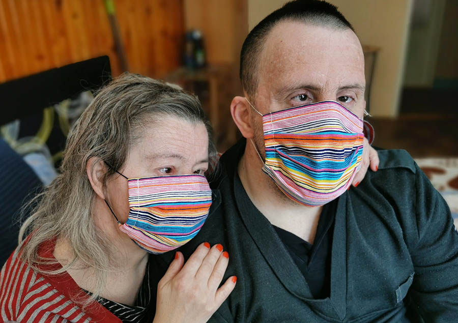Two adults wearing face masks