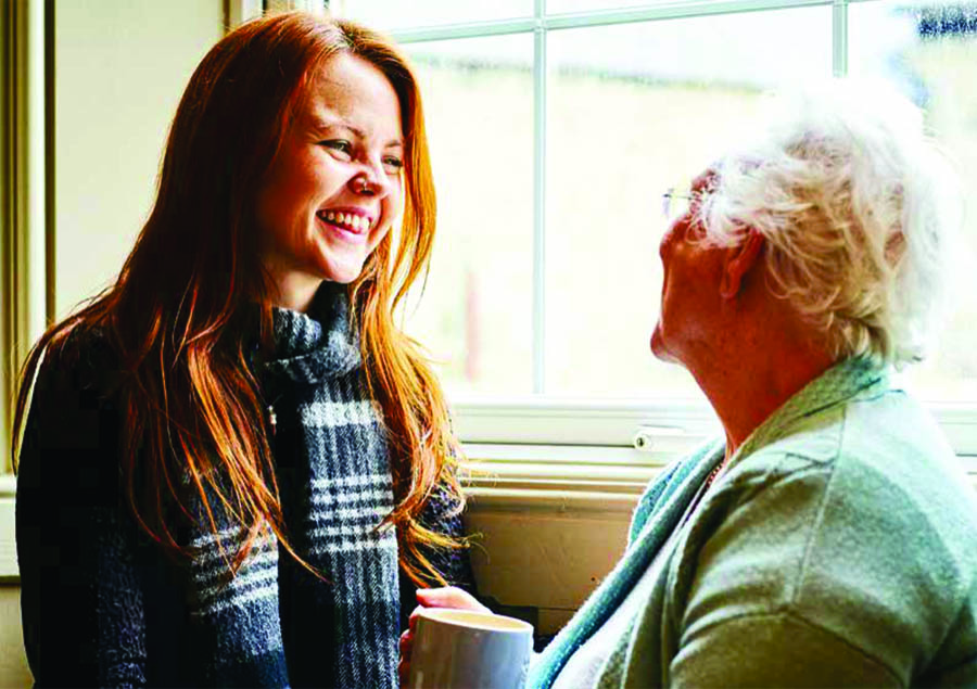 Young woman laughing with older woman